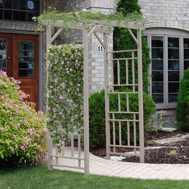 Geometric VineVista Vinyl Arbor installed in a garden, beautifully framed with colorful flowers and greenery, showcasing its sturdy and elegant design